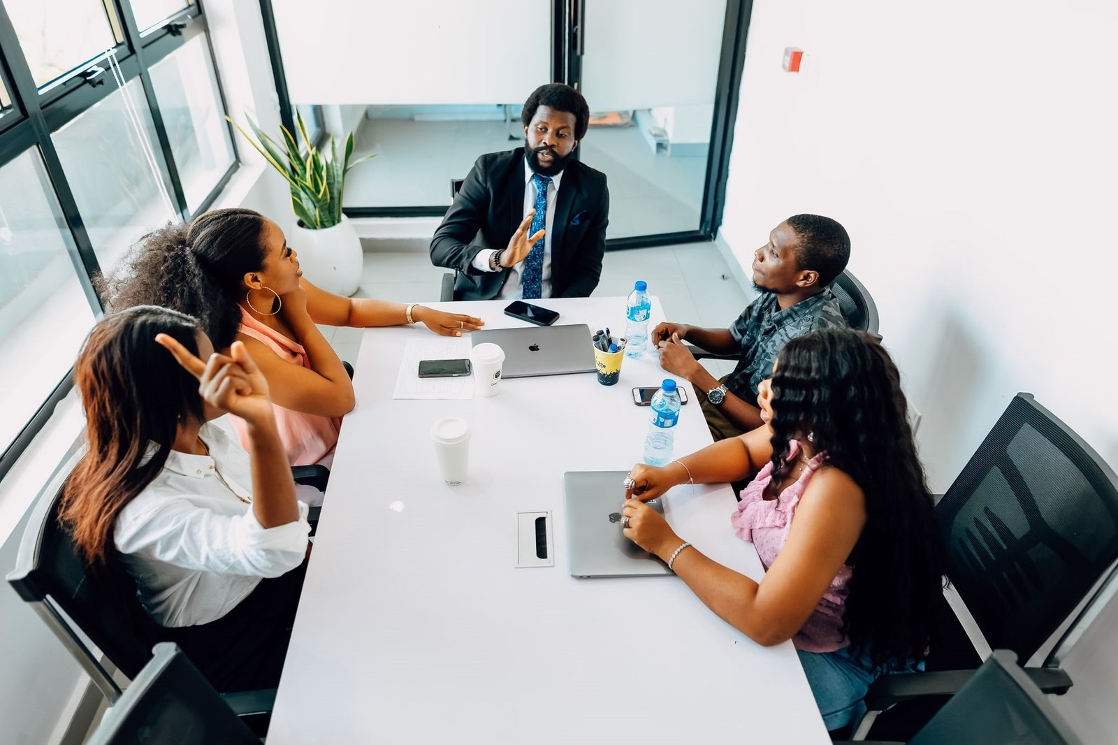Business team in a strategy meeting around a boardroom table in a bright Lagos office